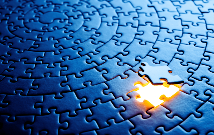 Solid blue puzzle. One piece is missing and the space is glowing a golden light